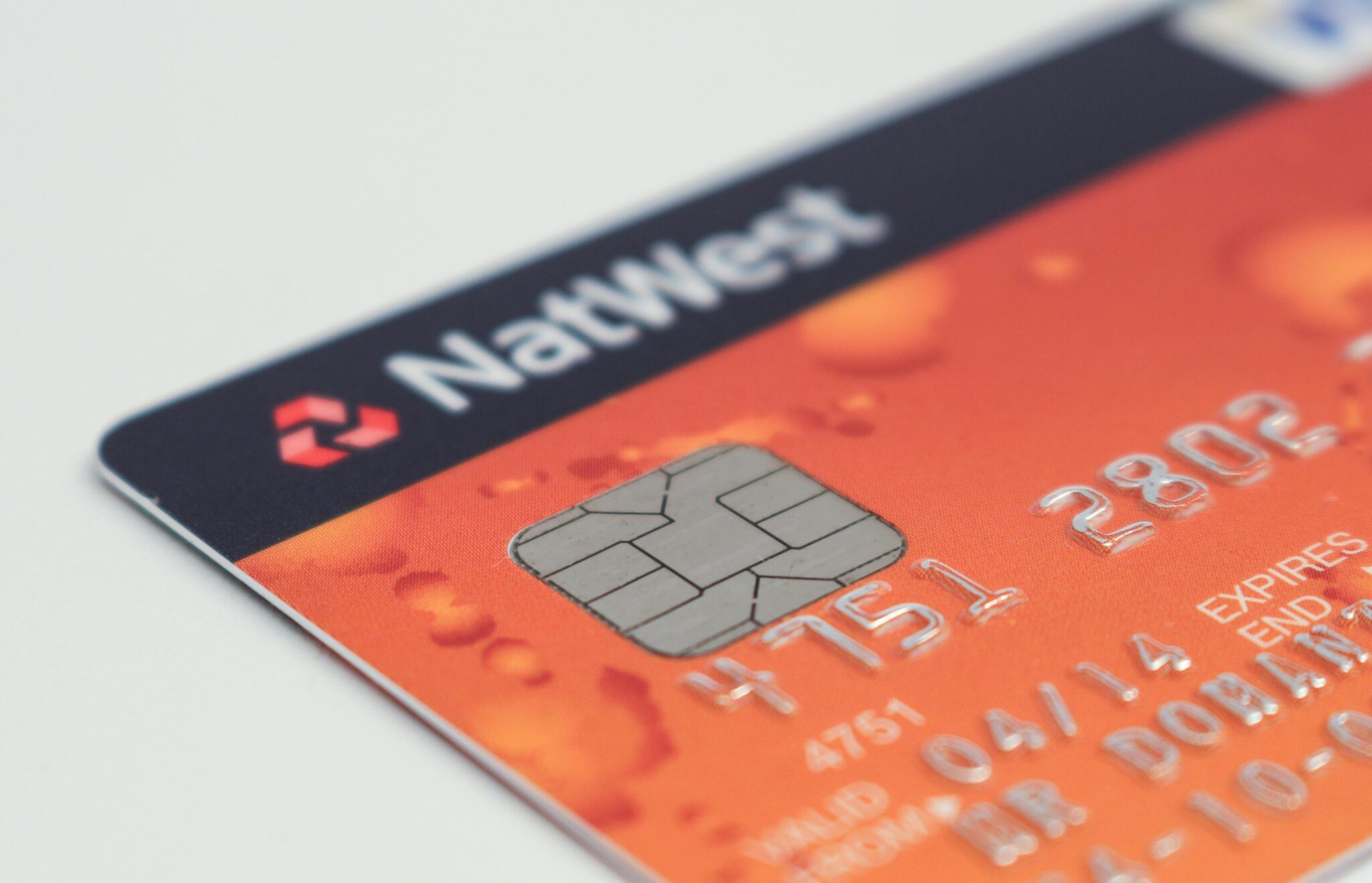 Detailed image of a credit card emphasizing the chip and card details.